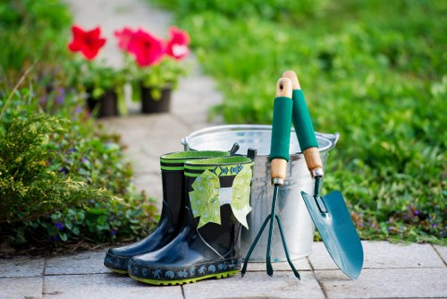 Gardener arranging labelled recycling bins in a St Johns Wood garden