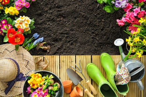 Gardener preparing soil and planting in St Johns Wood garden